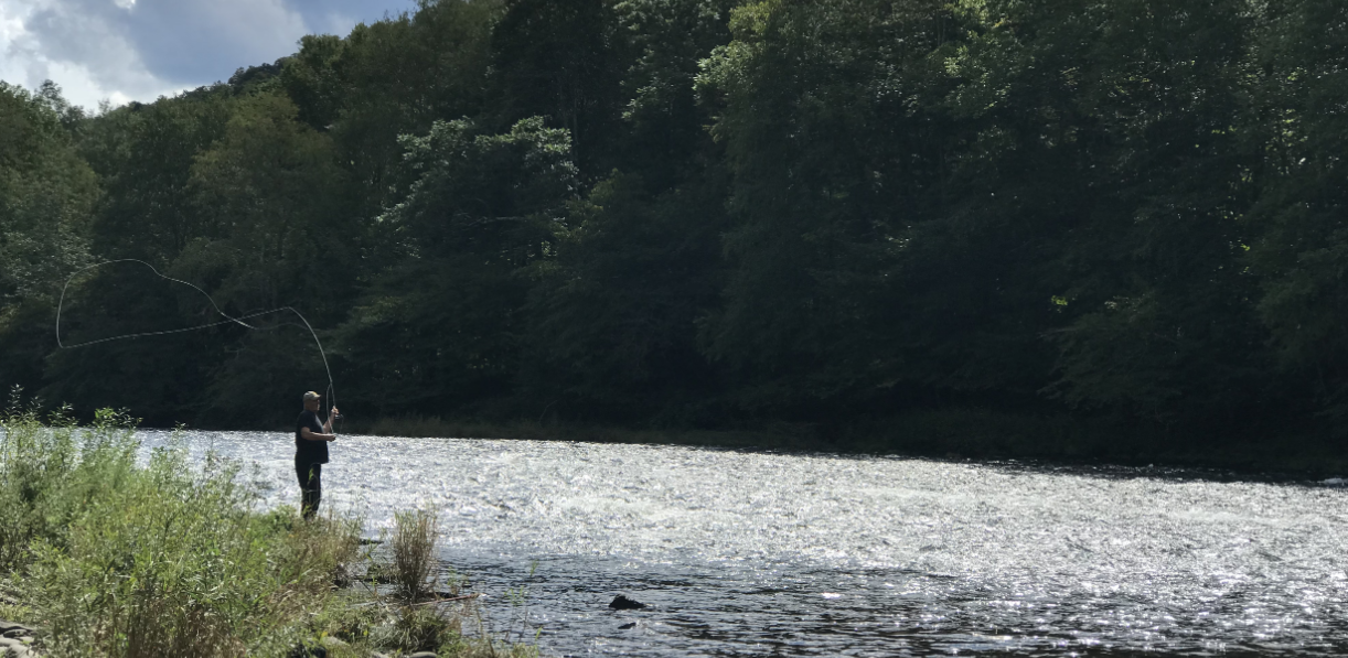 man fishing in a river